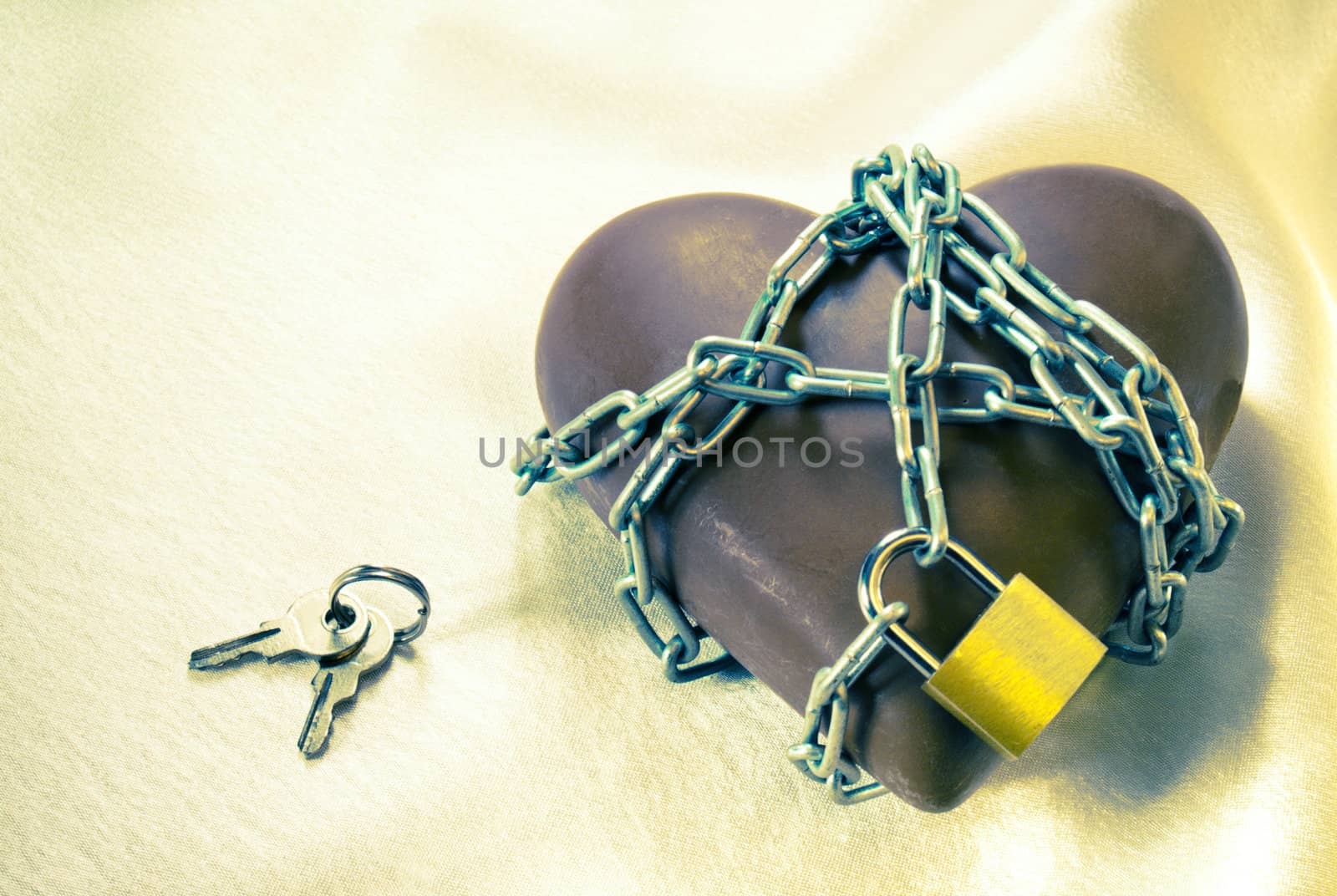 Heart shaped chocolate tied up with chains with lock and keys