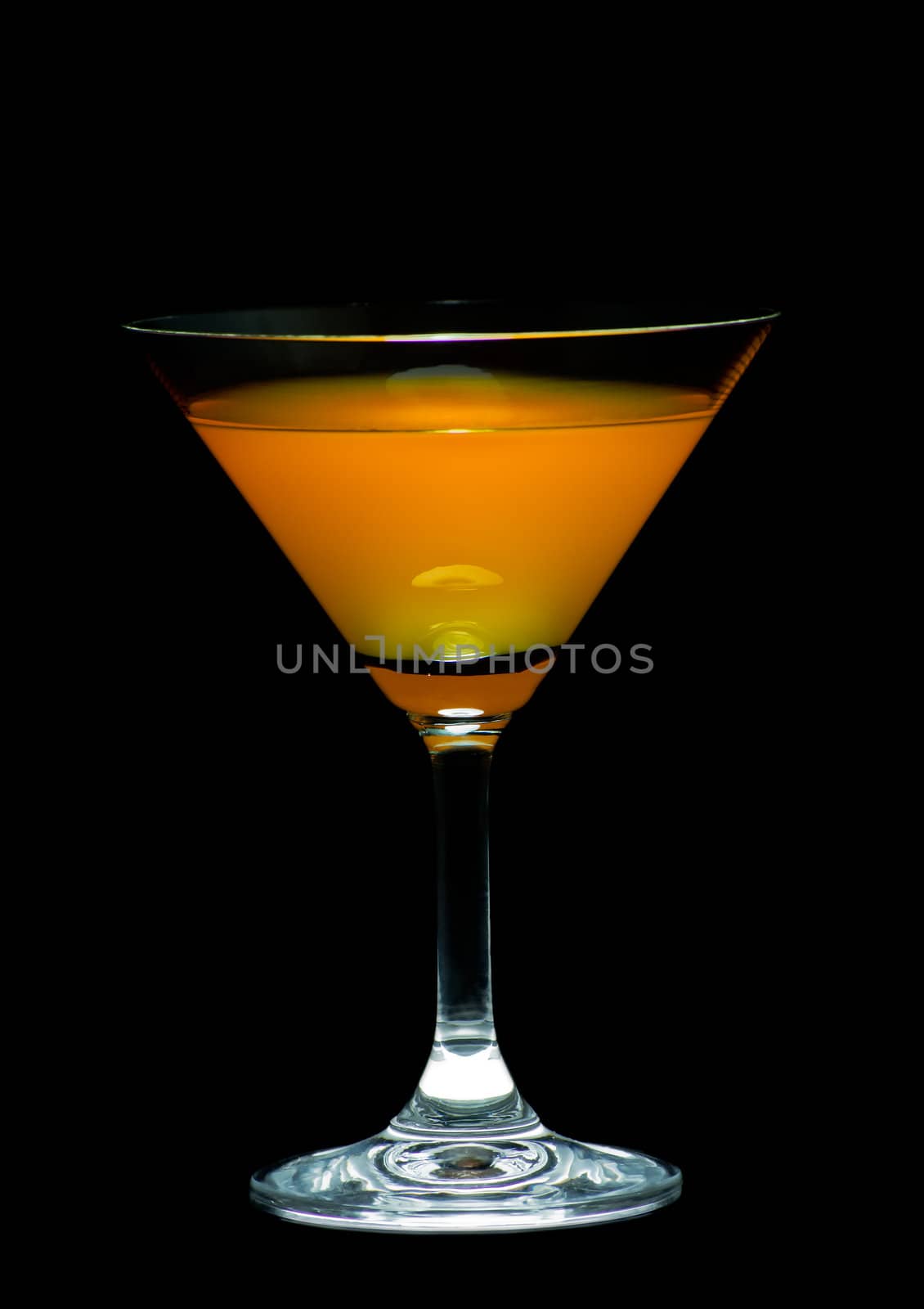 Orange juice in cocktail glass by nuttakit