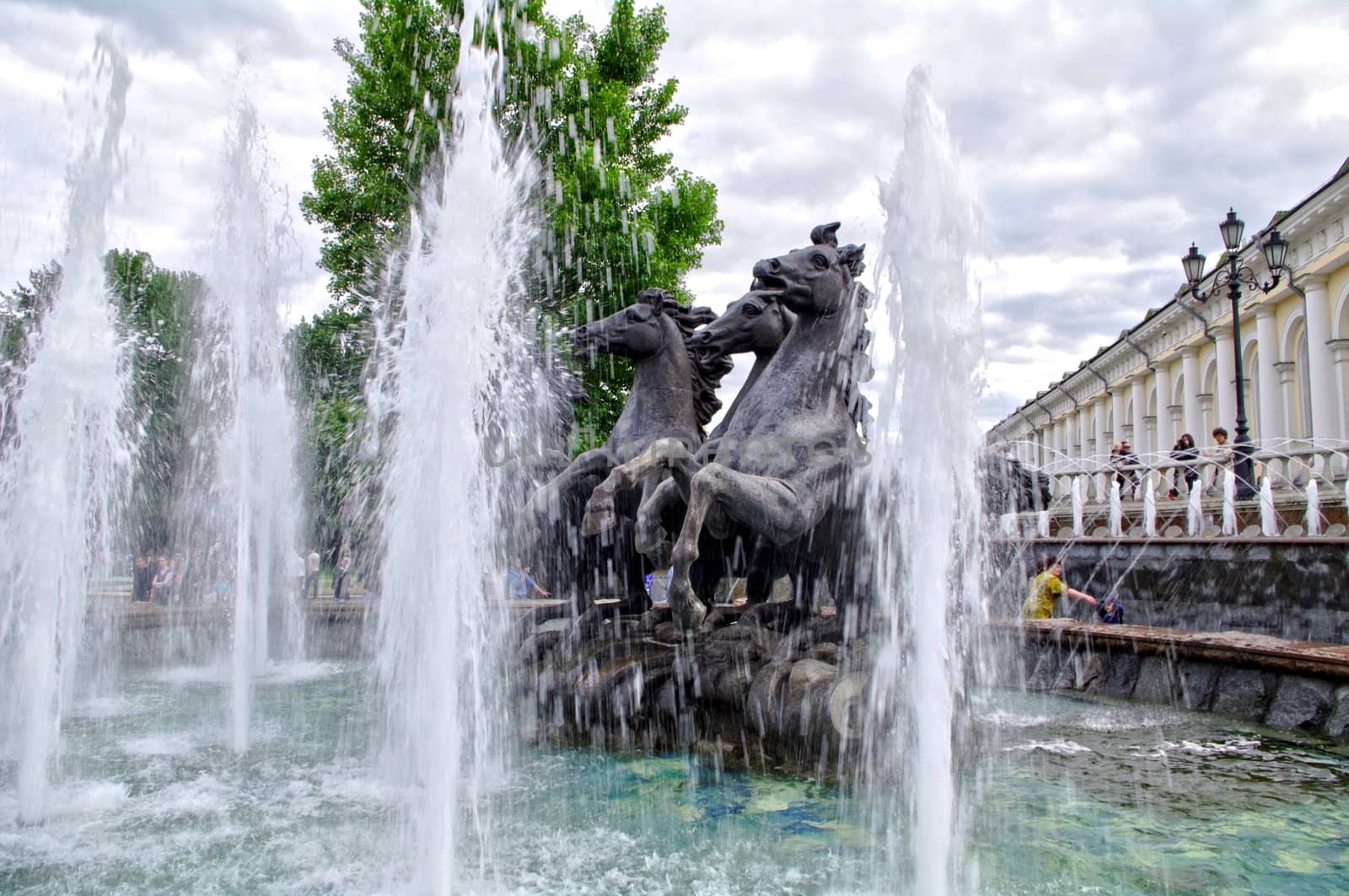 Moscow, Russia - June 14, 2010: Summer day. Peoples walk near the Fountain Russian troika on June 14, 2010 in Ohotniy ryad, Moscow, Russia by Stoyanov