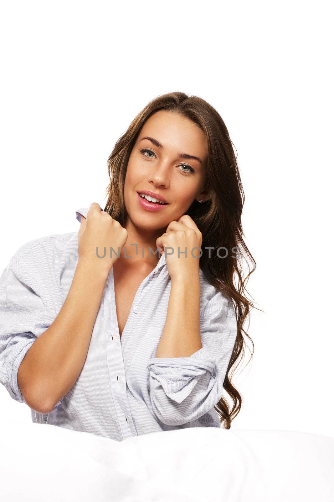 smiling woman in bed holding her collar on white background