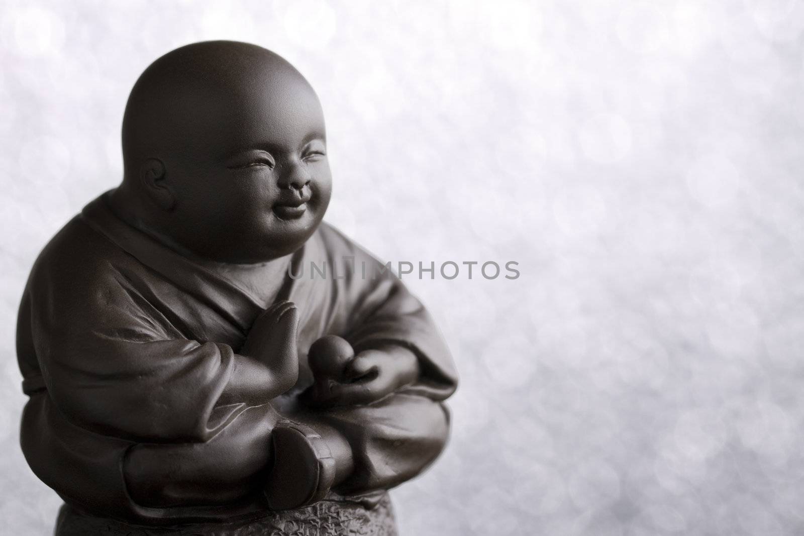 Small brown Buddha figurine representing the precepts.