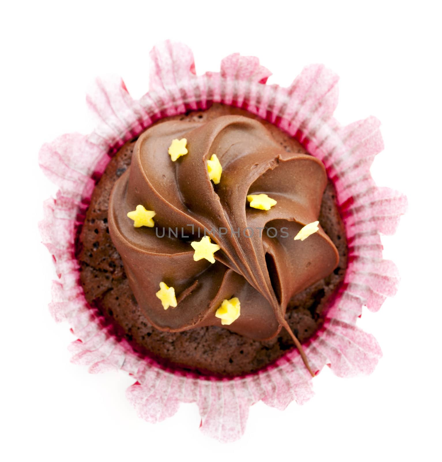 Directly above view of chocolate cupcake with frosting and stars.
