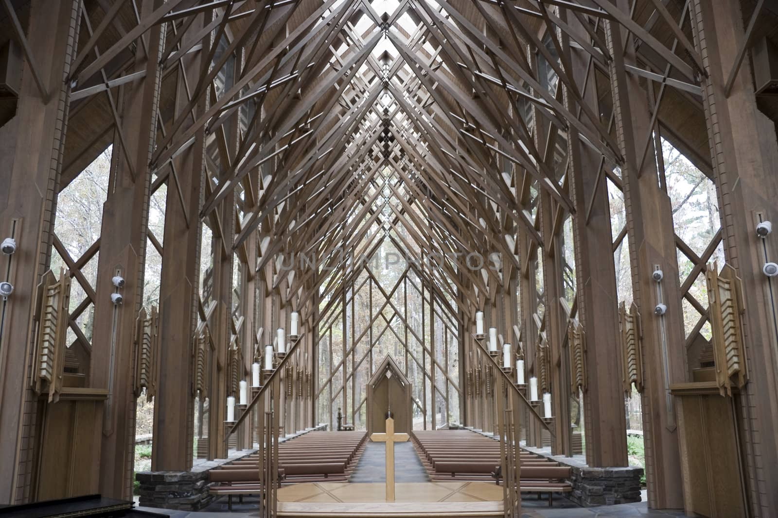 The insides of a wooden and glass church from the alter