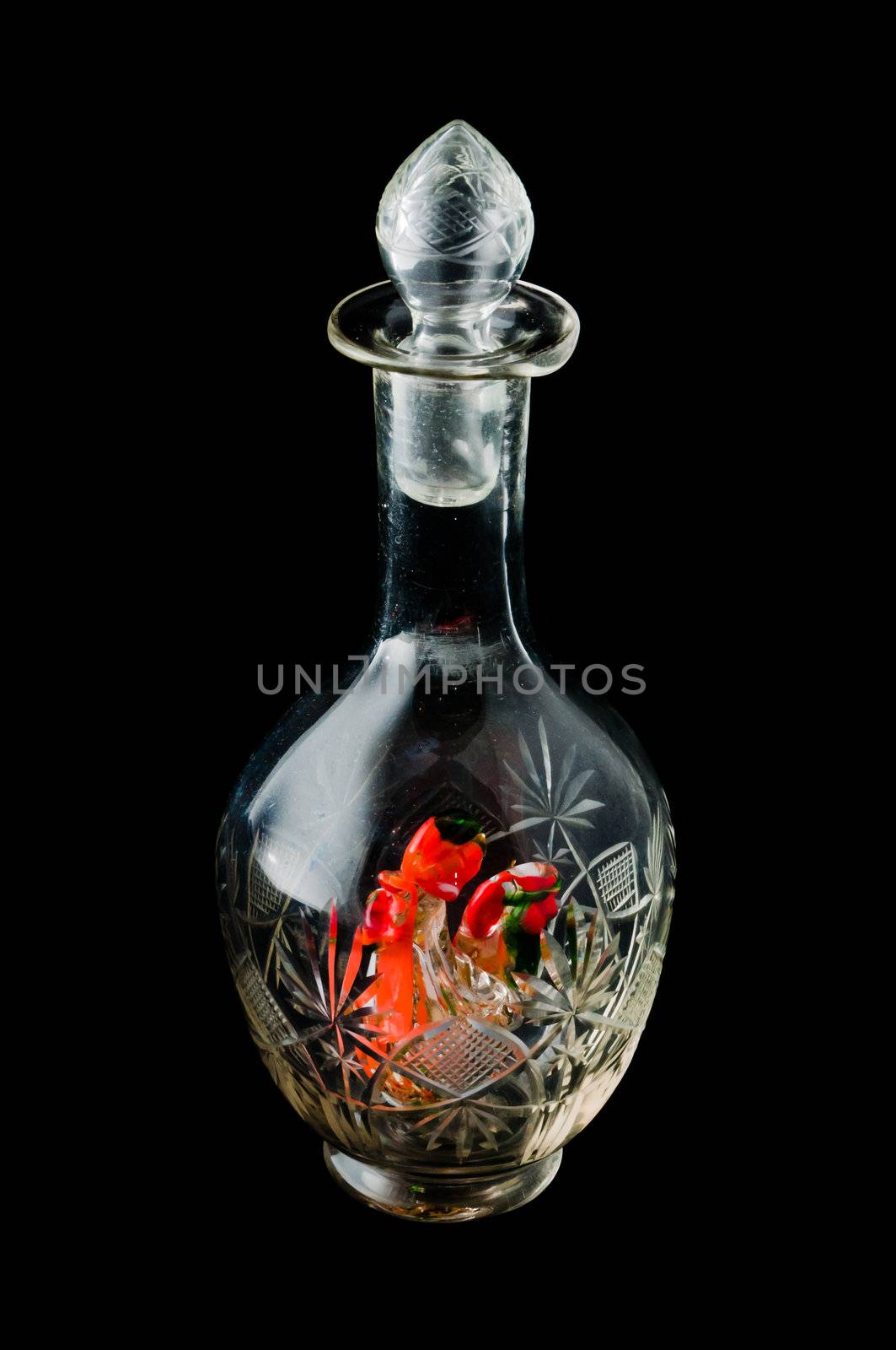 Empty decanter with pattern and colored bird figure inside