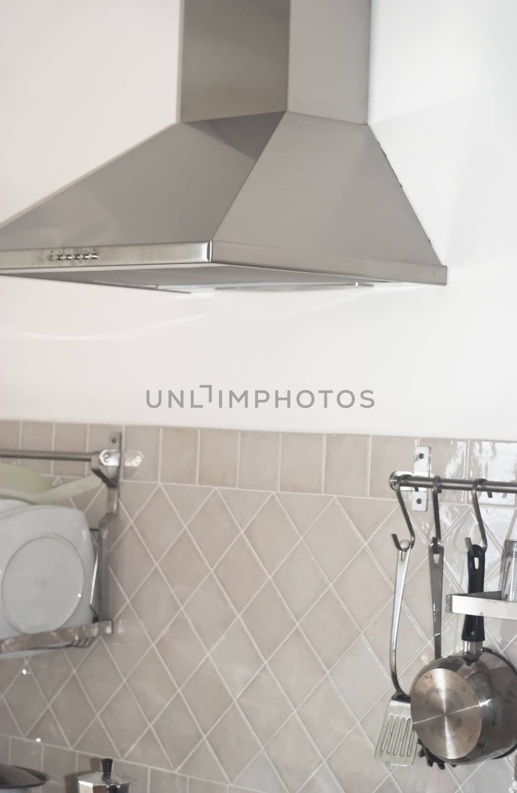 detail of a modern kitchen with modern metallic cooker hood 