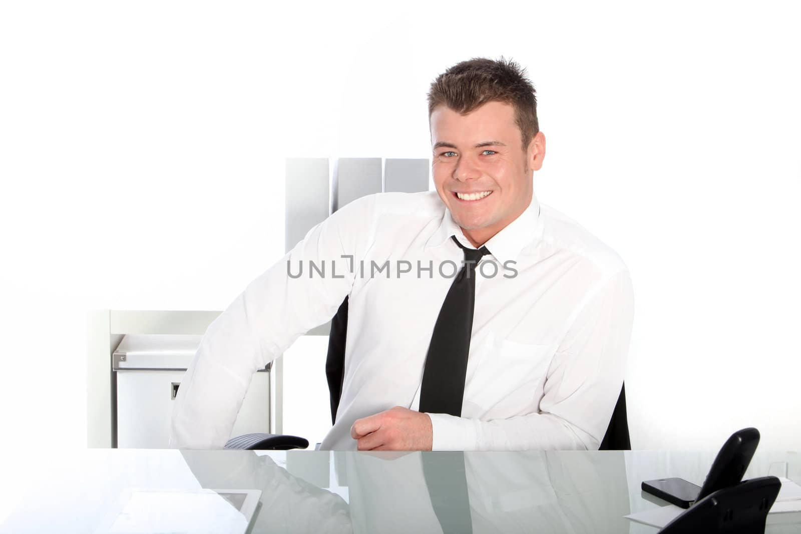 Smiling businessman sitting against the white background