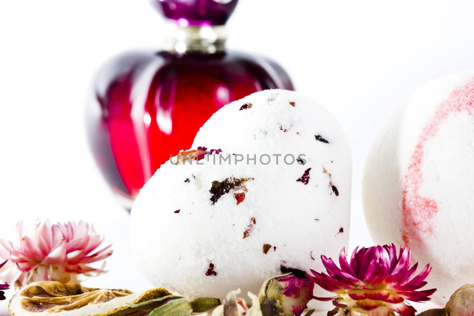 perfume with air-dried flowers on white