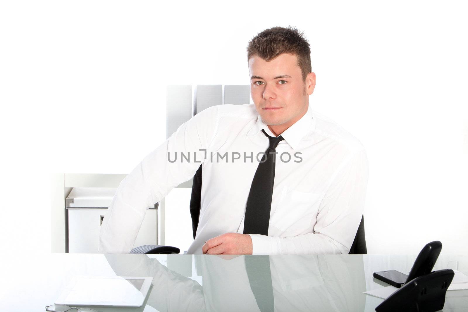 Portrait of handsome businessman sitting inside his office