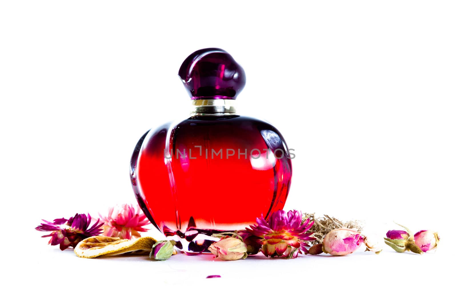 perfume with air-dried flowers on white