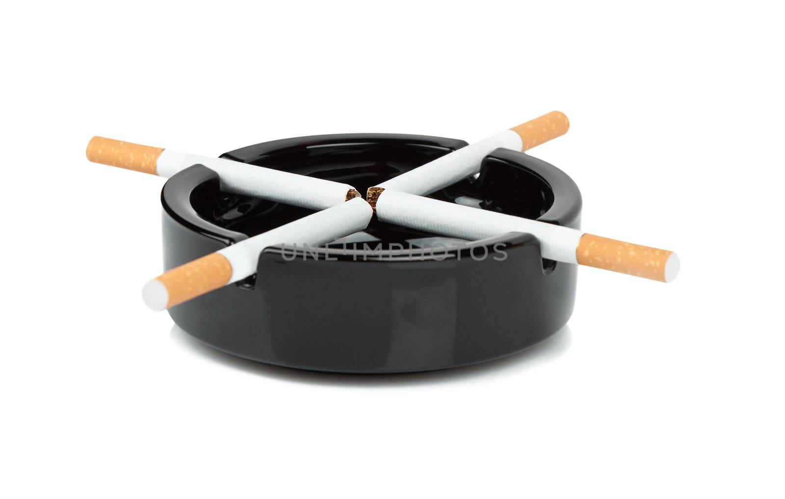 Cigarettes are a black ashtray on a white background