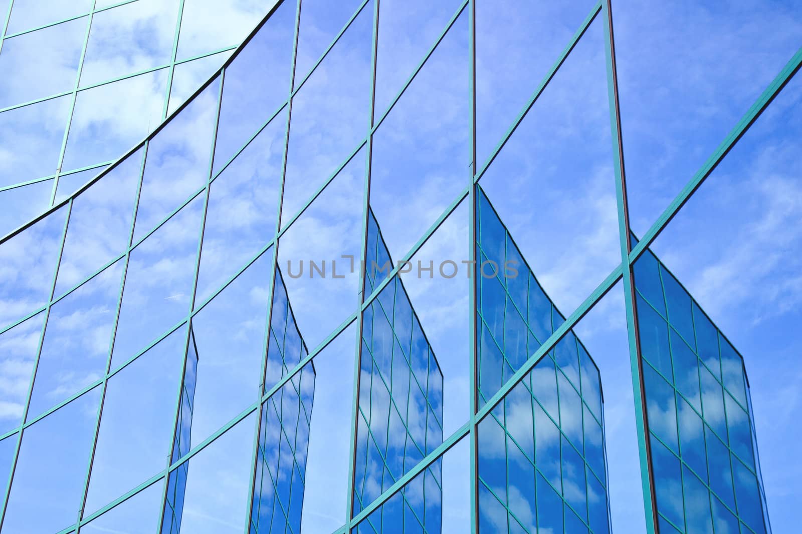 five reflections of facade with blue sky and clouds