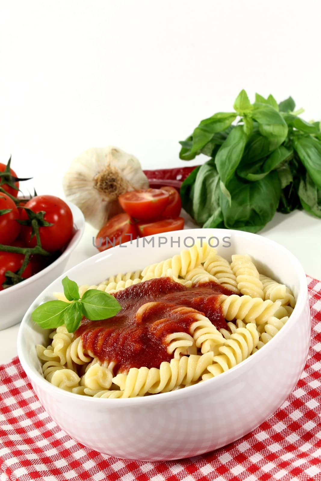 cooked pasta with tomato sauce and basil