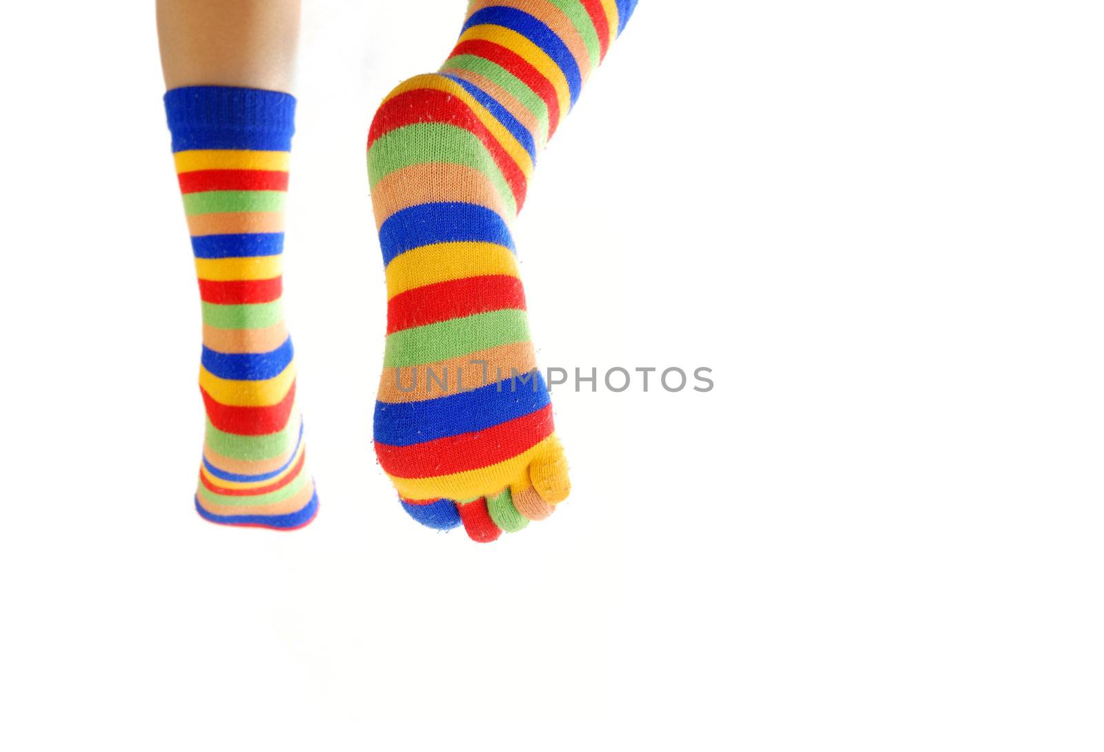 Close-up photo of the legs in colored socks going away