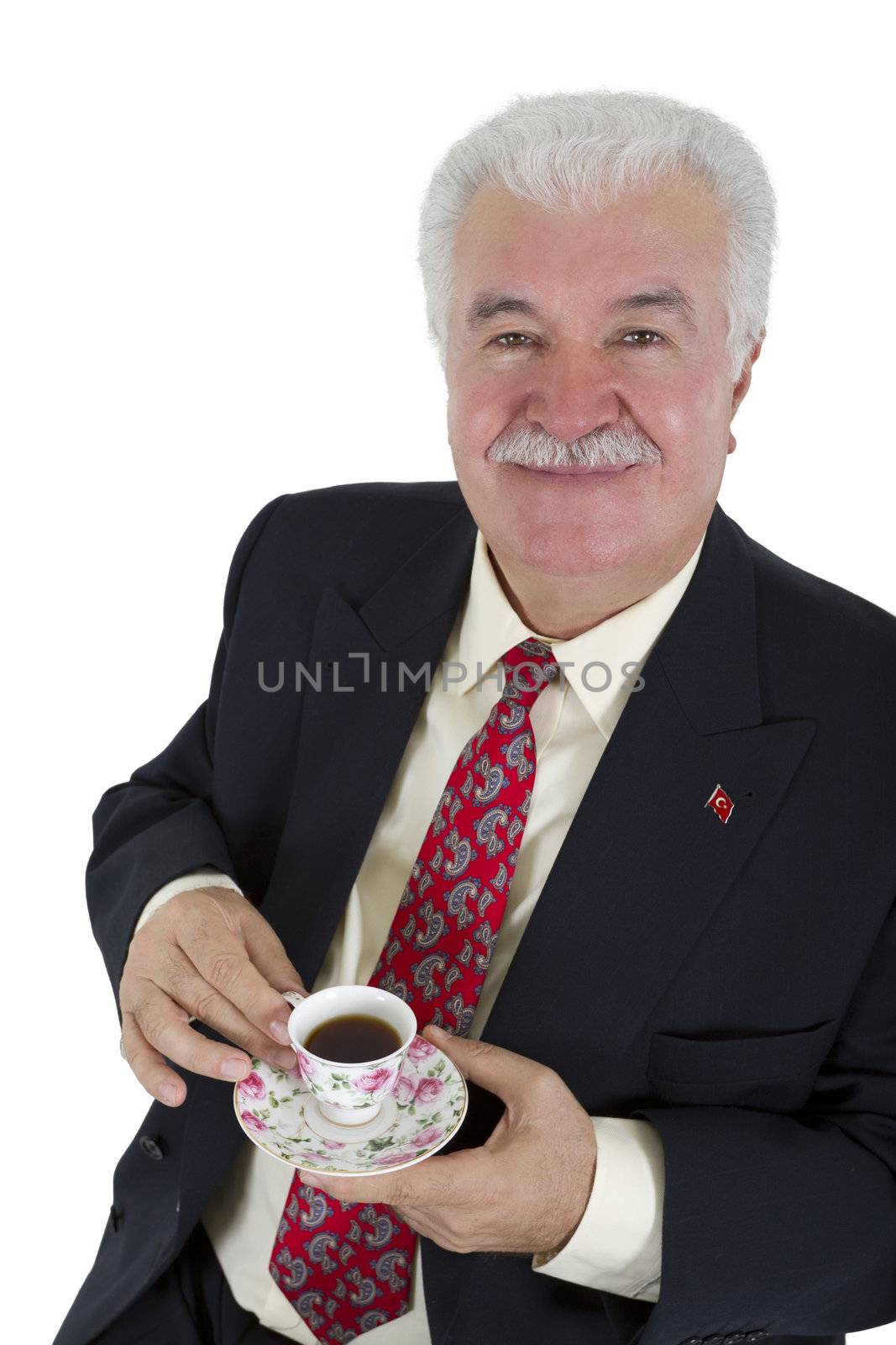 Turkish business man drinking his coffee, wearing red tie and suit. Isolated on white.