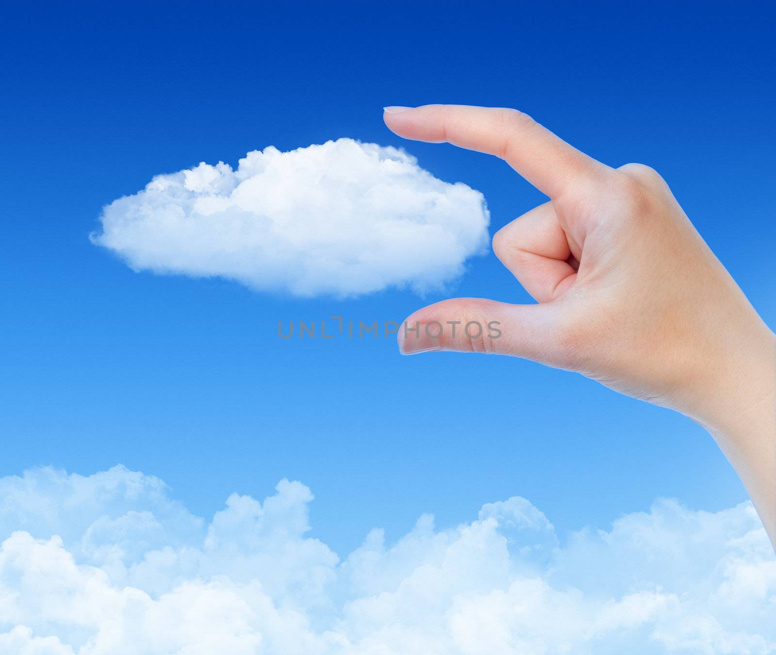 Woman hand measures the cloud against blue sky with clouds. Concept image on cloud computing and eco theme.