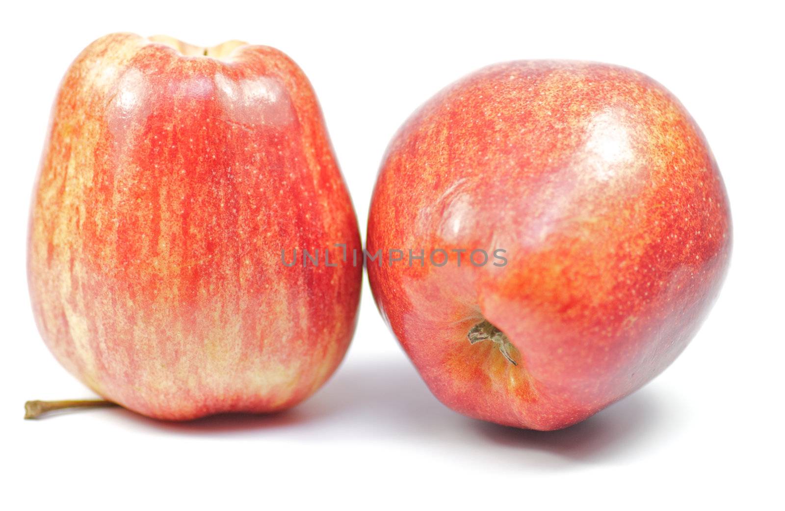 Two red apples on white background by zhekos
