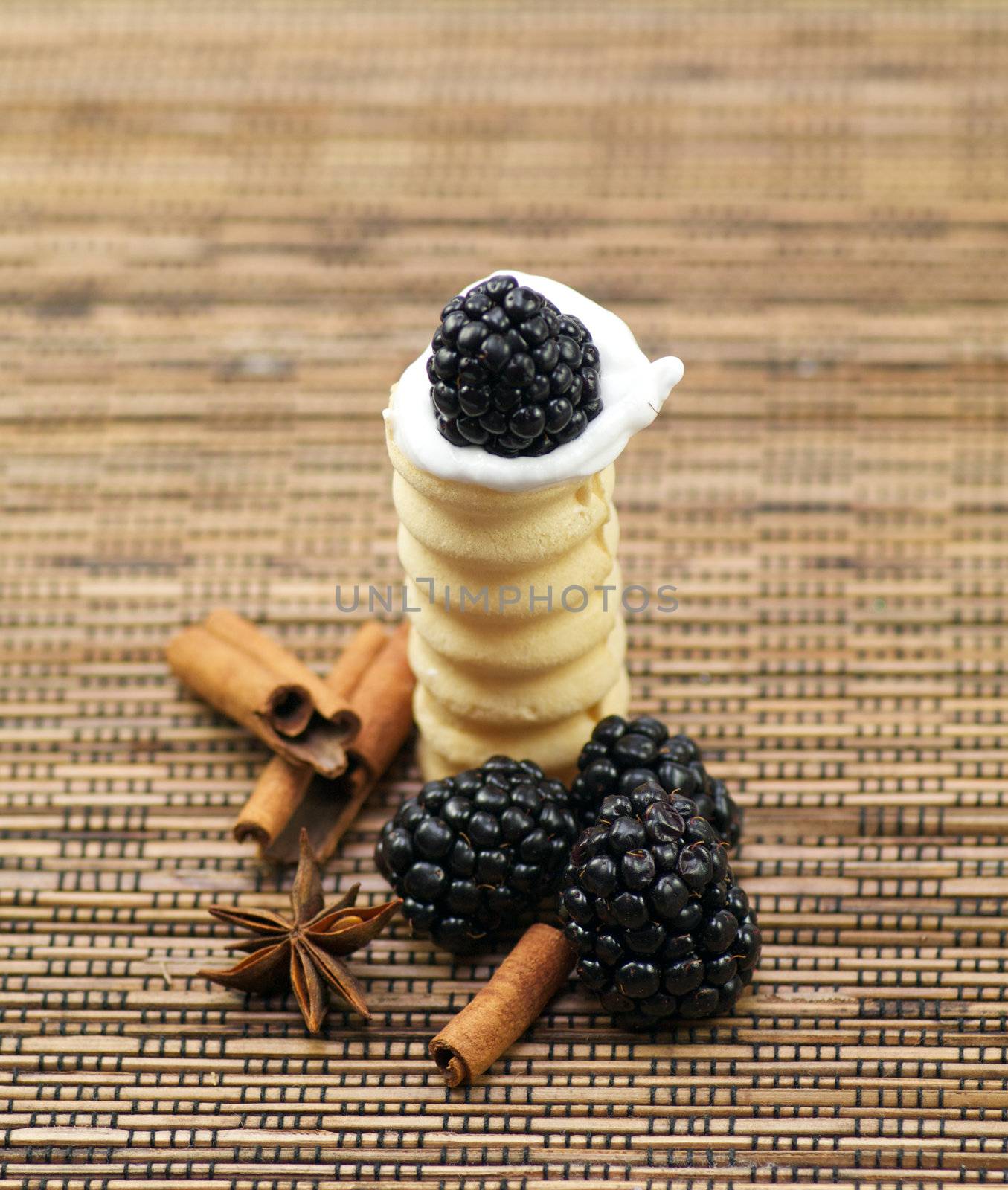 Small baskets from shortcake dough with whipped cream, a blackberry, cinnamon and anise