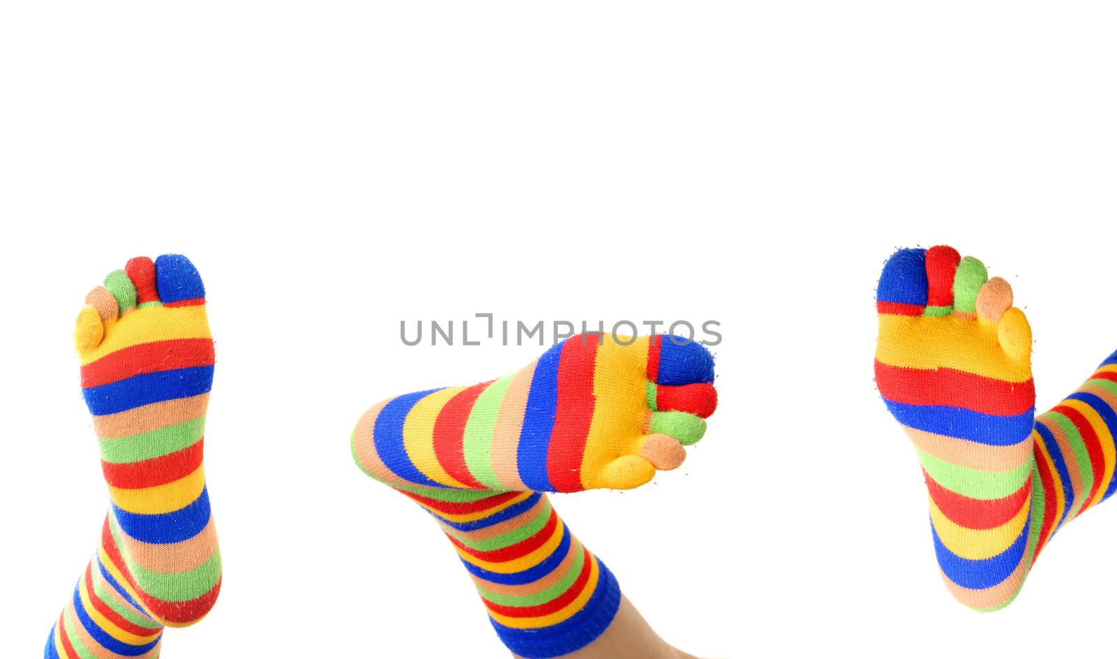 Close-up photo of three foots in colored zebrine socks