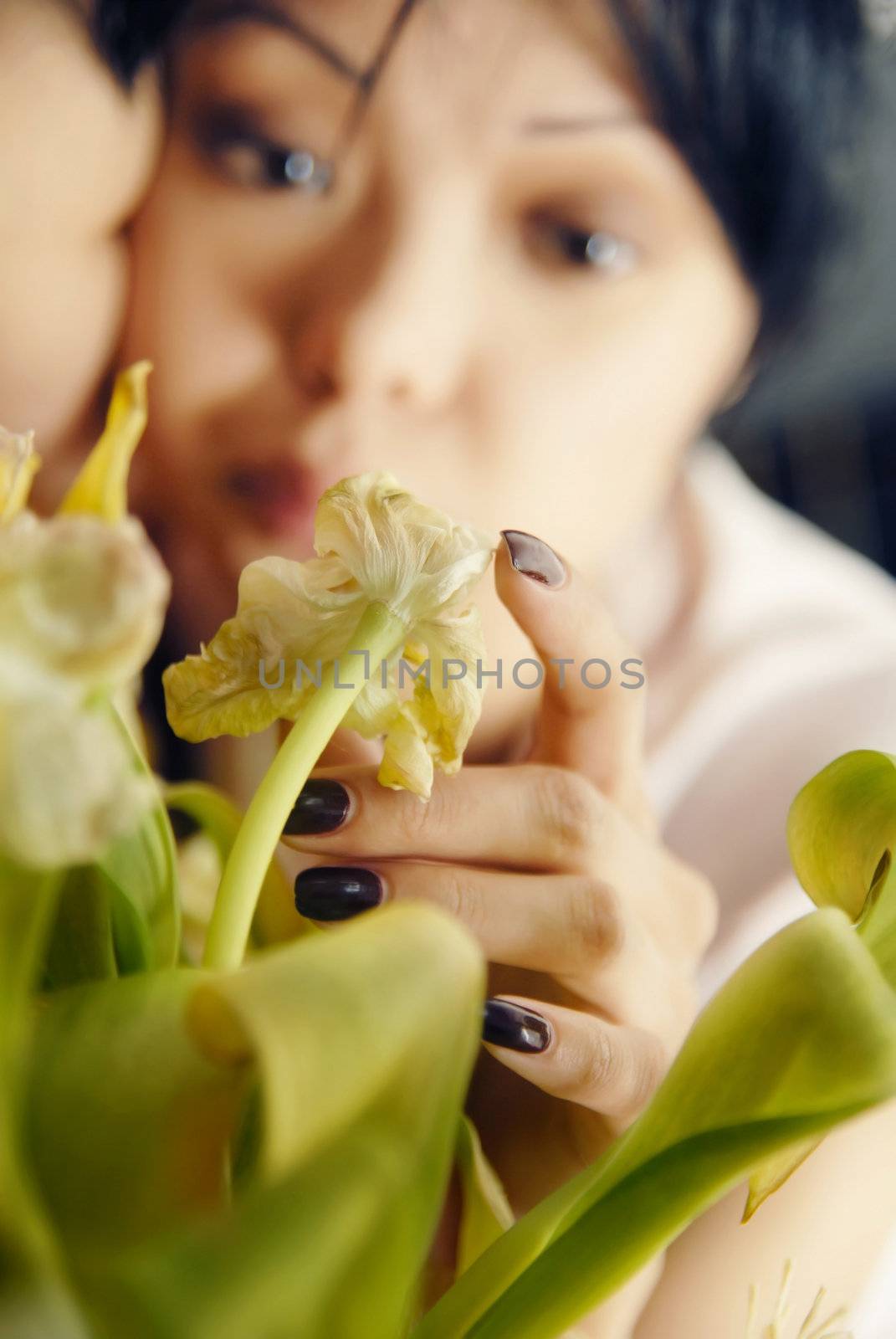 Photo of sad woman touching the plant and waiting for somebody