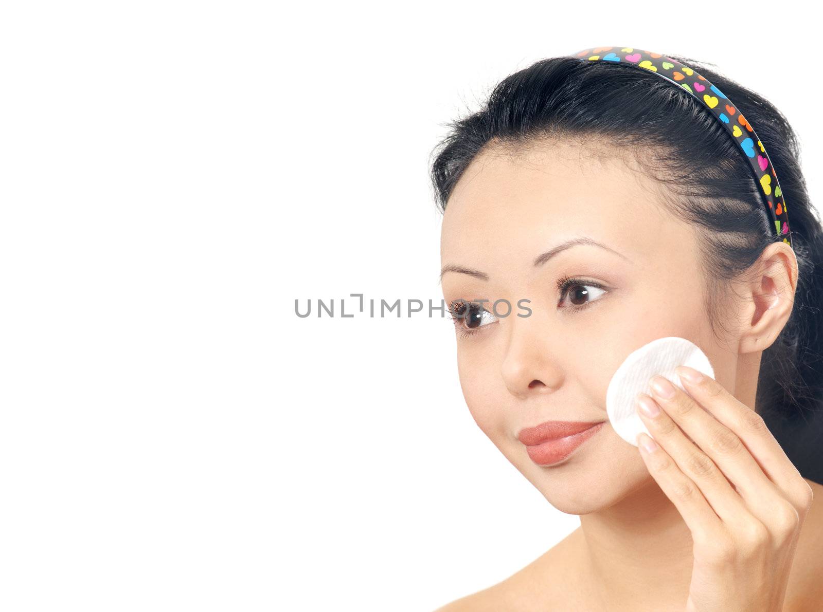 Asian woman cleaning face by cosmetic sponge