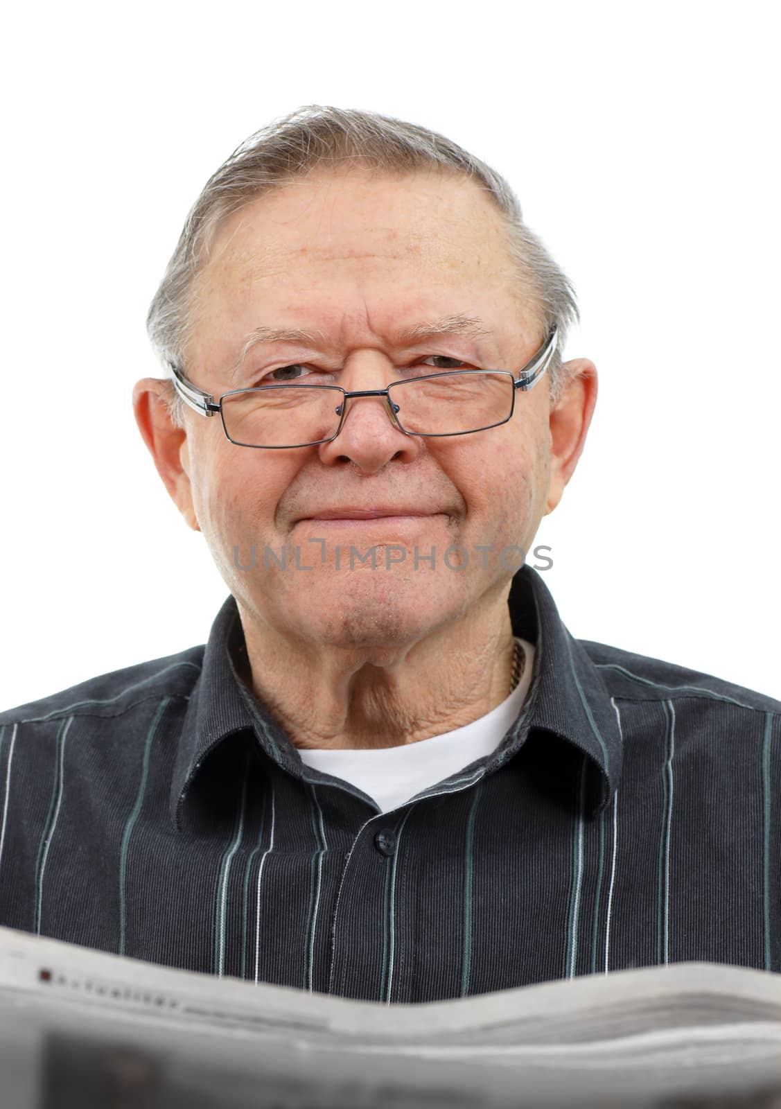 Happy senior man smiling looking up as he reads the morning's newspaper isolated on white