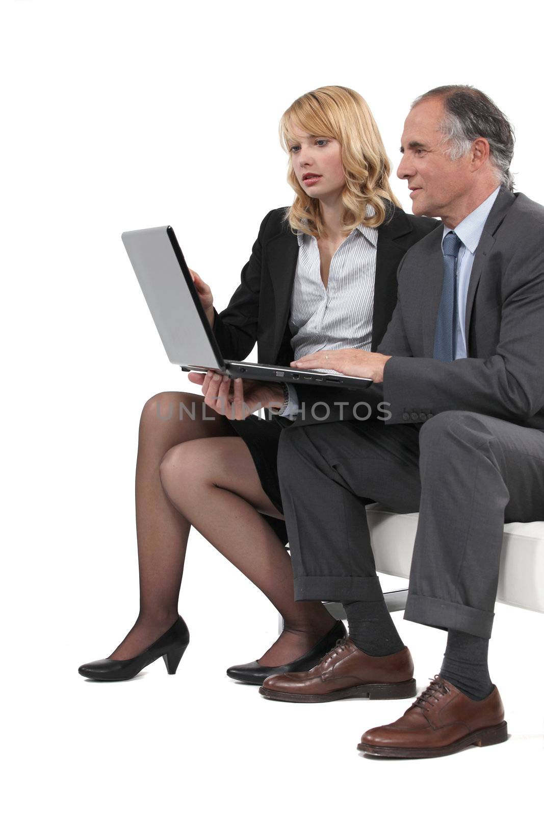 Boss and employee looking at laptop by phovoir