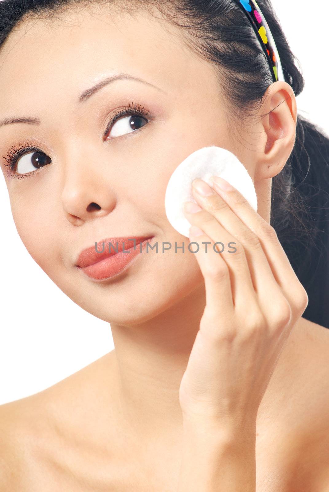 Brunette with cleaning pad on her face