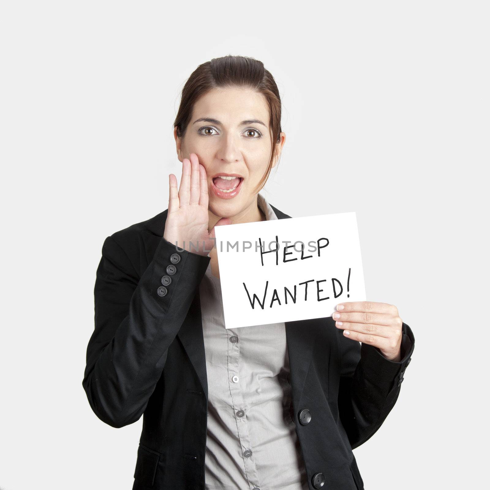 Business woman calling for help holding a cardboard with the text message "Help Wanted"
