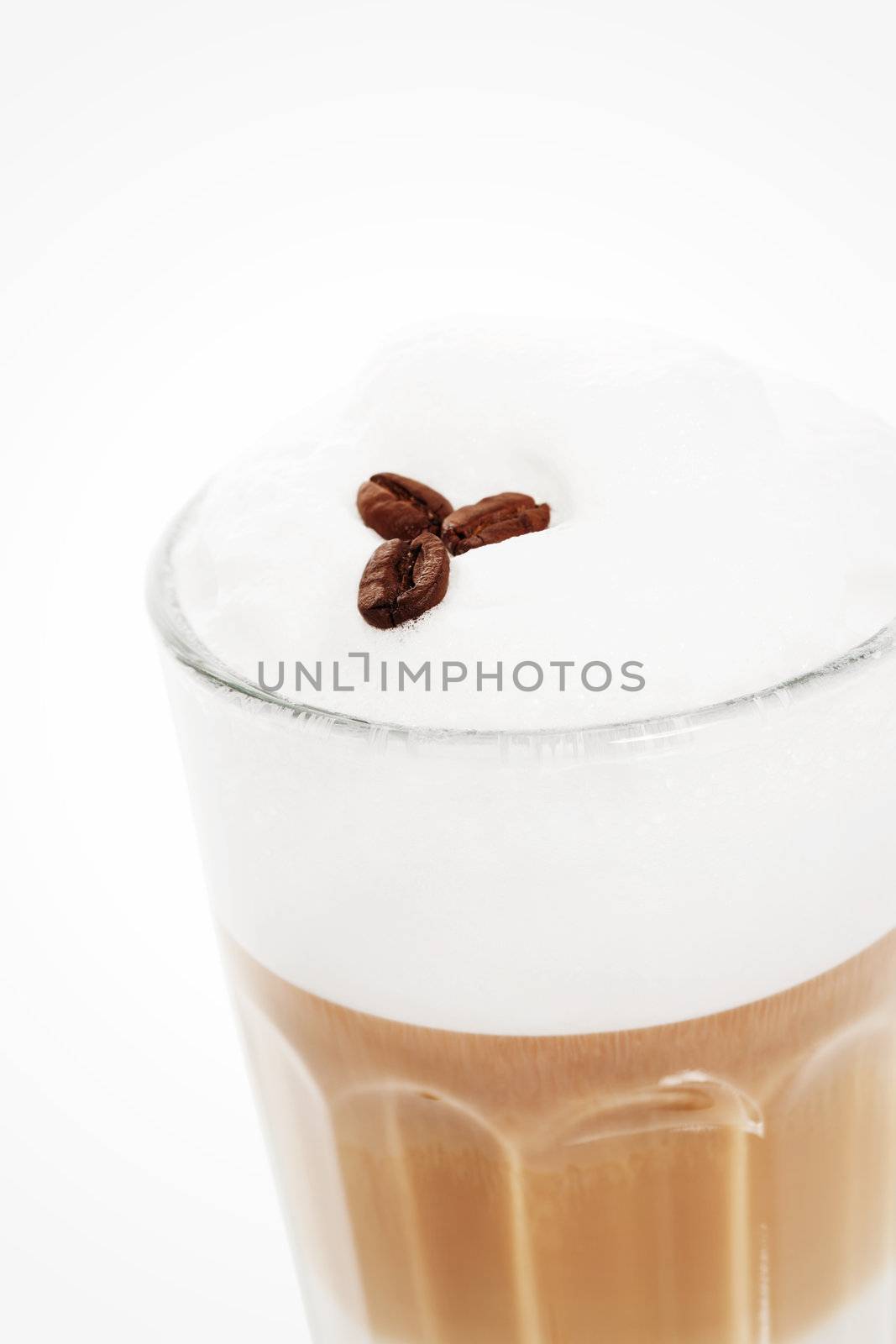 closeup of coffee beans on a latte macchiato foam