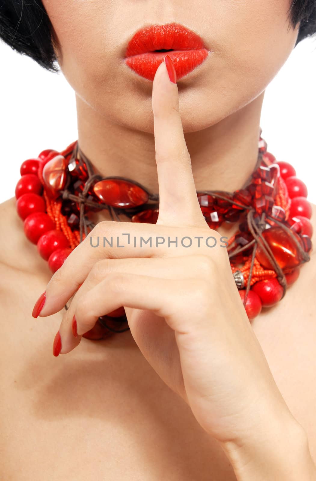 Woman in red chaplet with finger on her lips