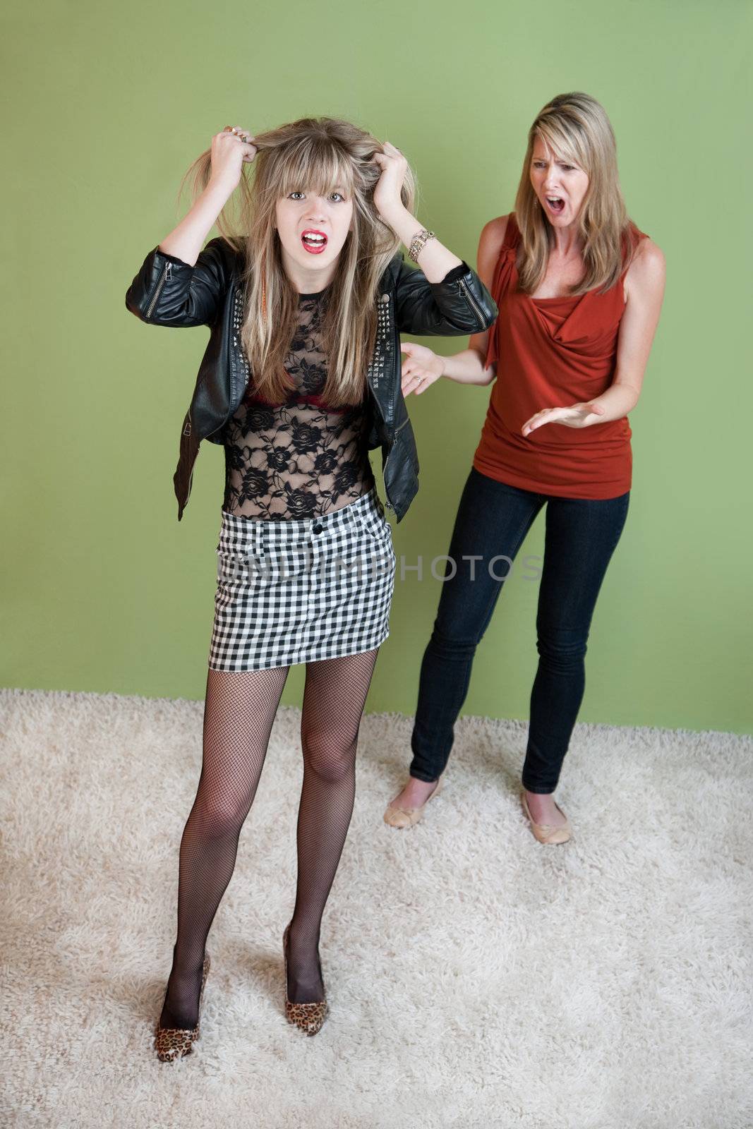 Unhappy mom  with daughter in provocative clothing