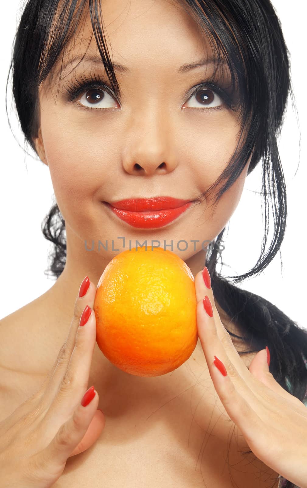 Portrait of smiling woman holding a fresh orange