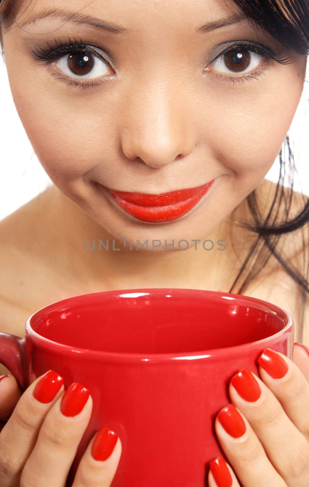 Smiling model holding red cup with drink or eat