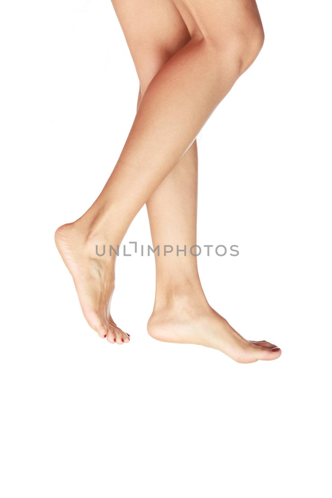 Barefoot woman legs walking on a white background