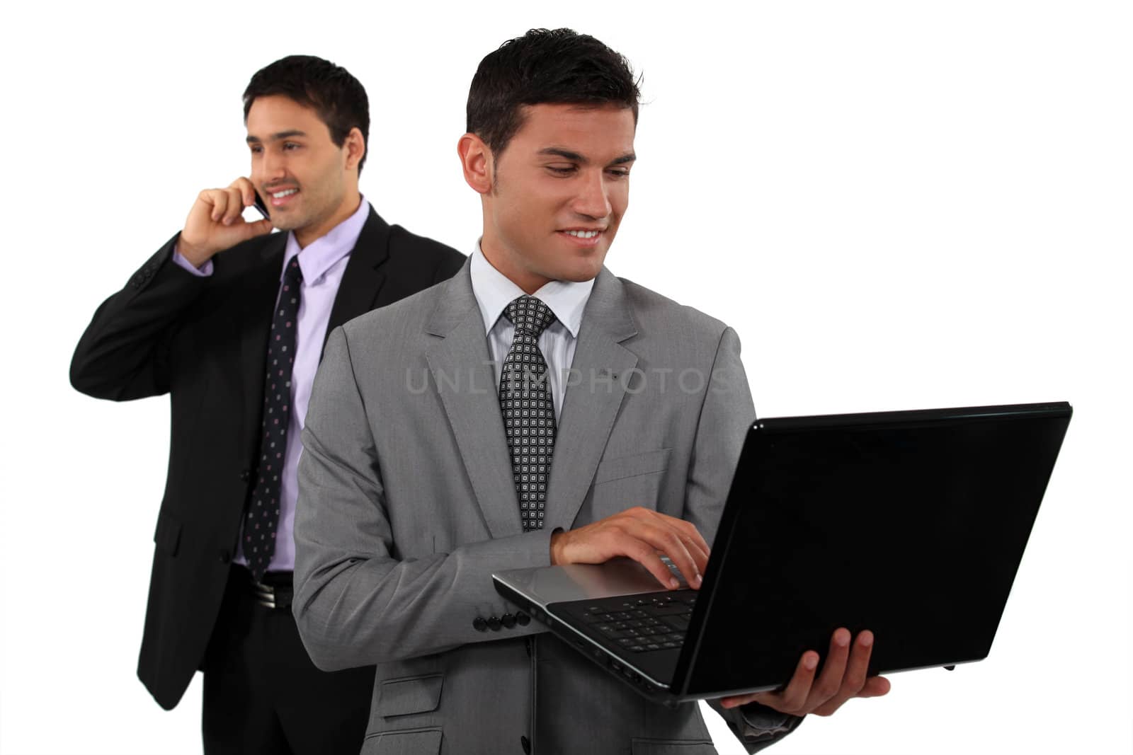 Two young businessmen embracing technology by phovoir