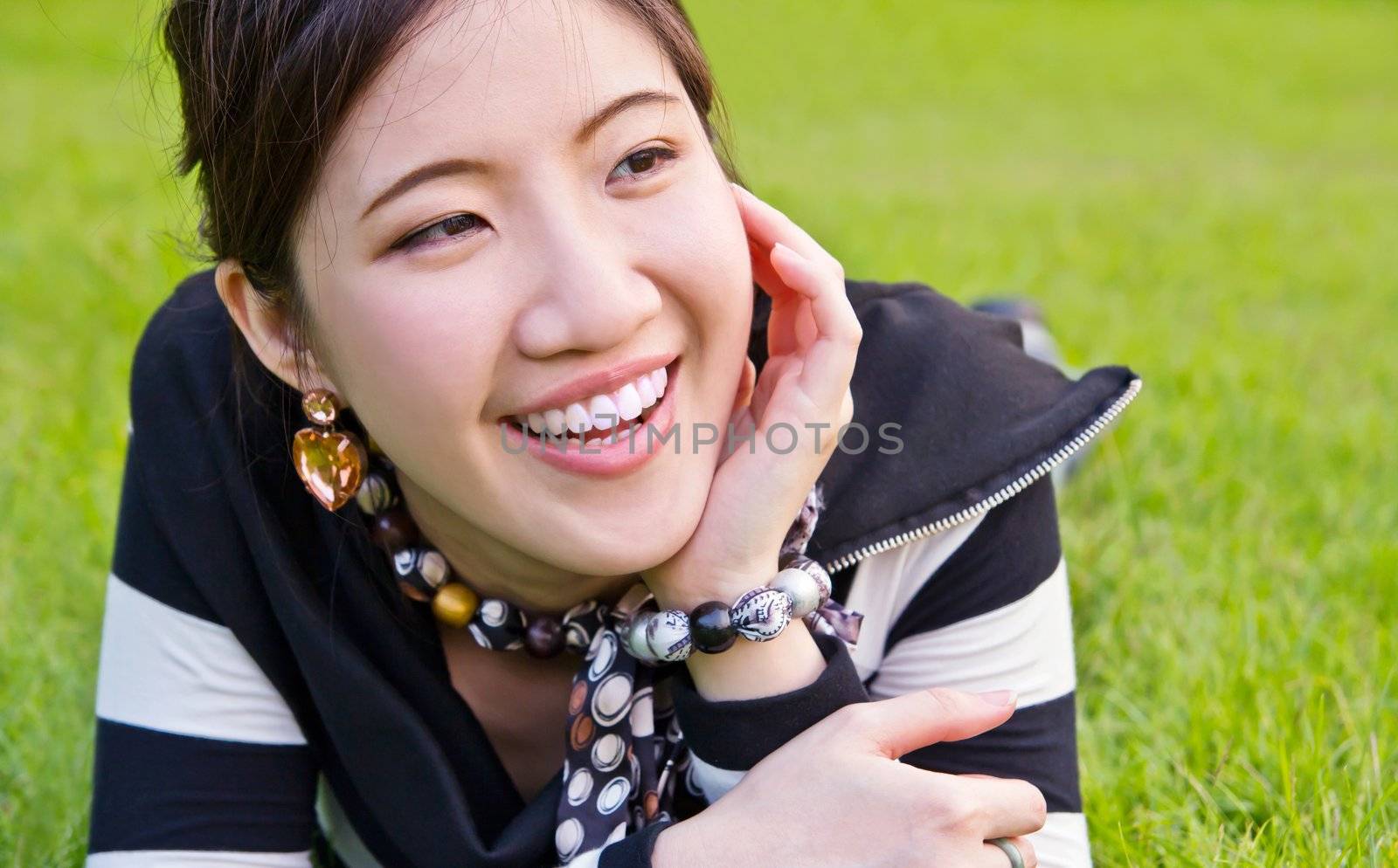 Asian woman relaxing on the grass