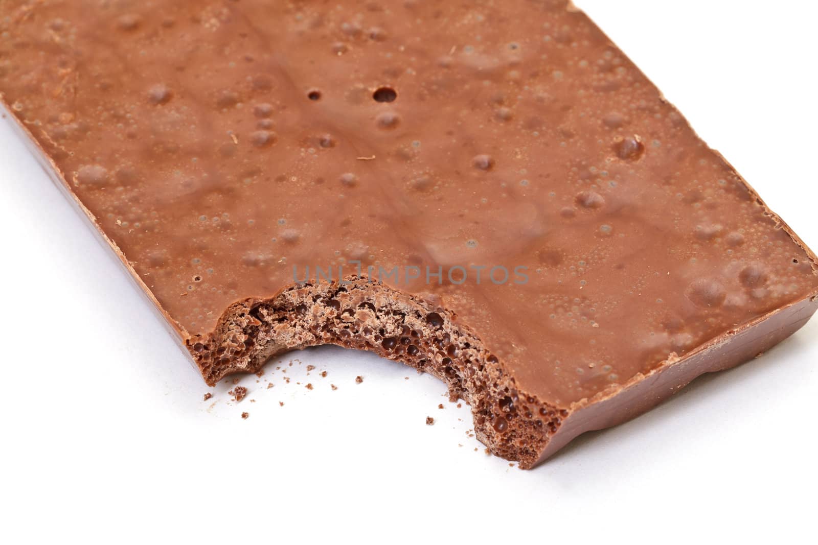 nibbled chocolate bar on white background