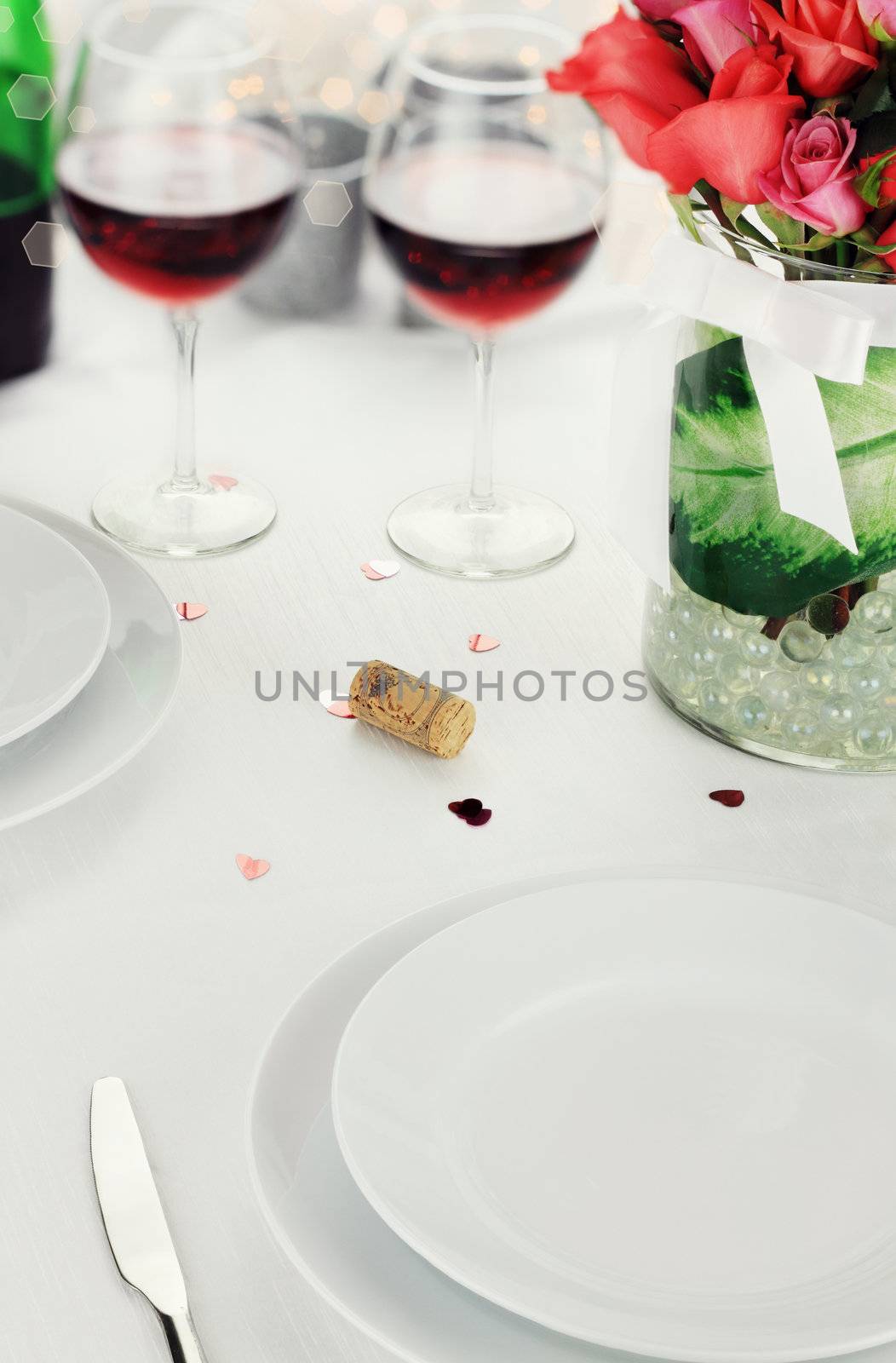 Romantic table setting with selective focus on lower portion of image.