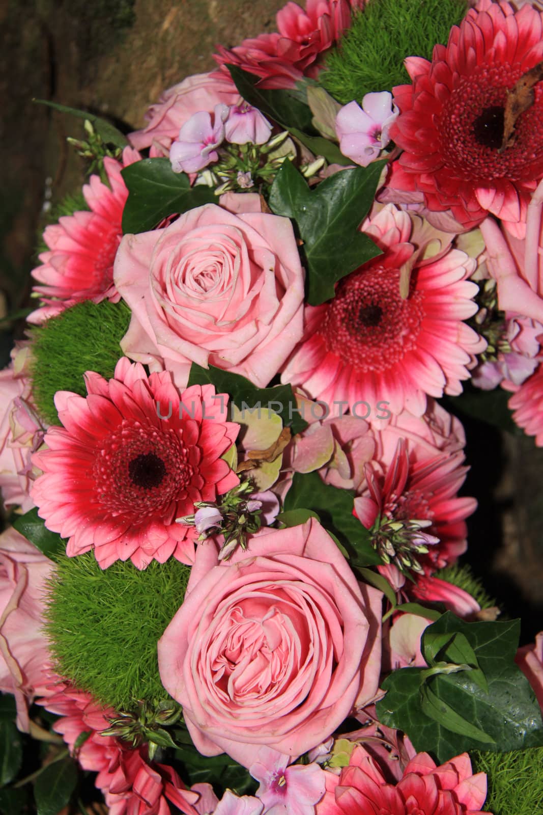 Floral arrangement in pink, roses and gerberas in sunlight