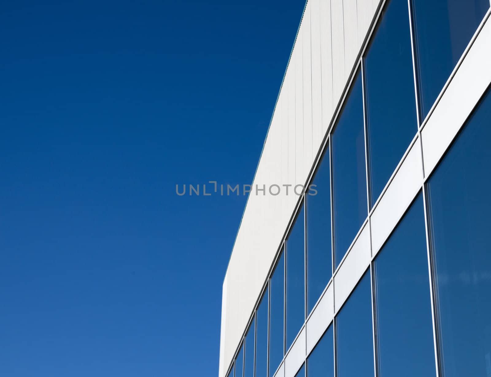 modern buildings windows with blue sky reflection