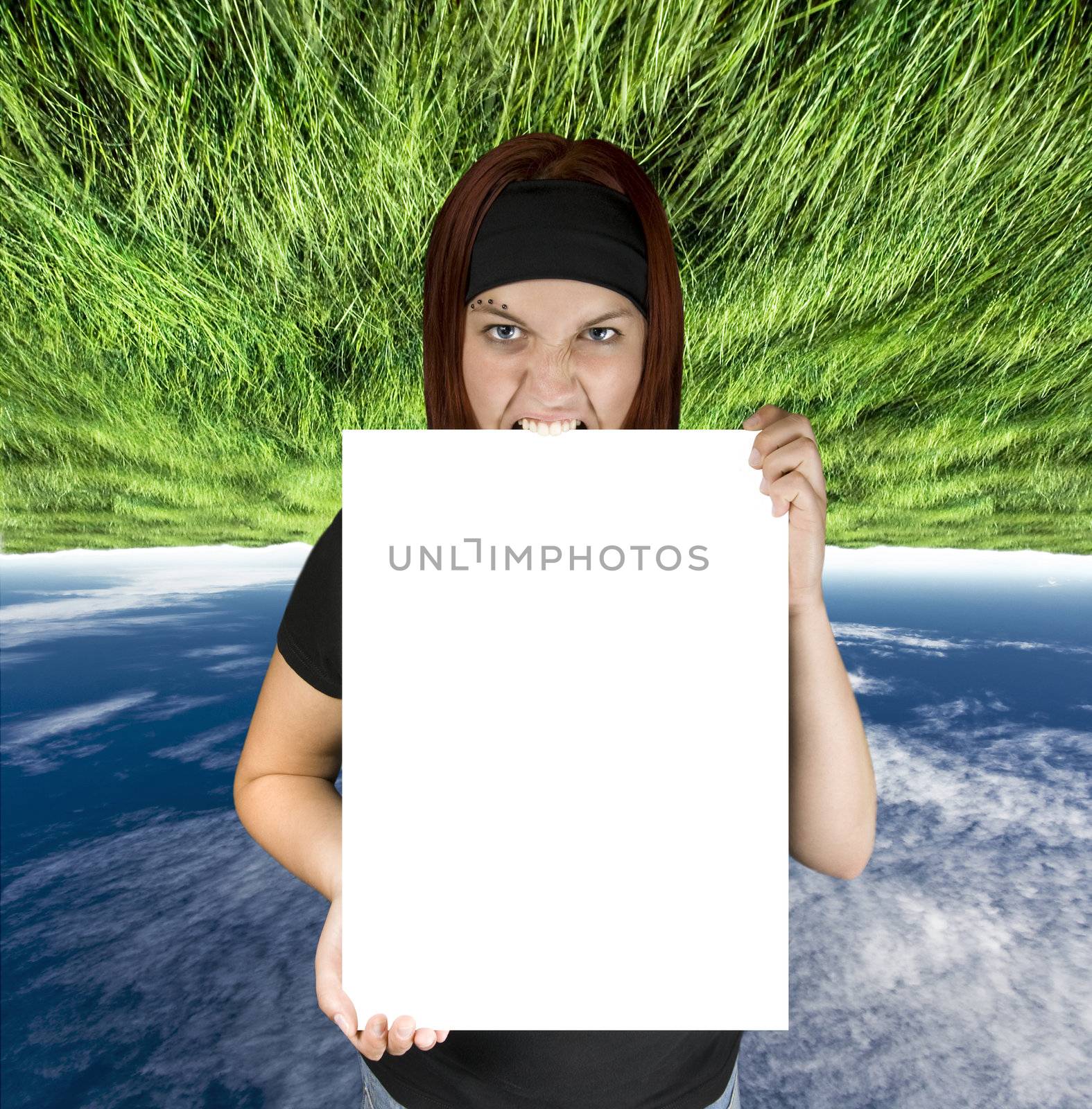Redhead girl holding a pure white isolated canvas suitable for design replacement of any kind.

Shot in studio. Composite background.
