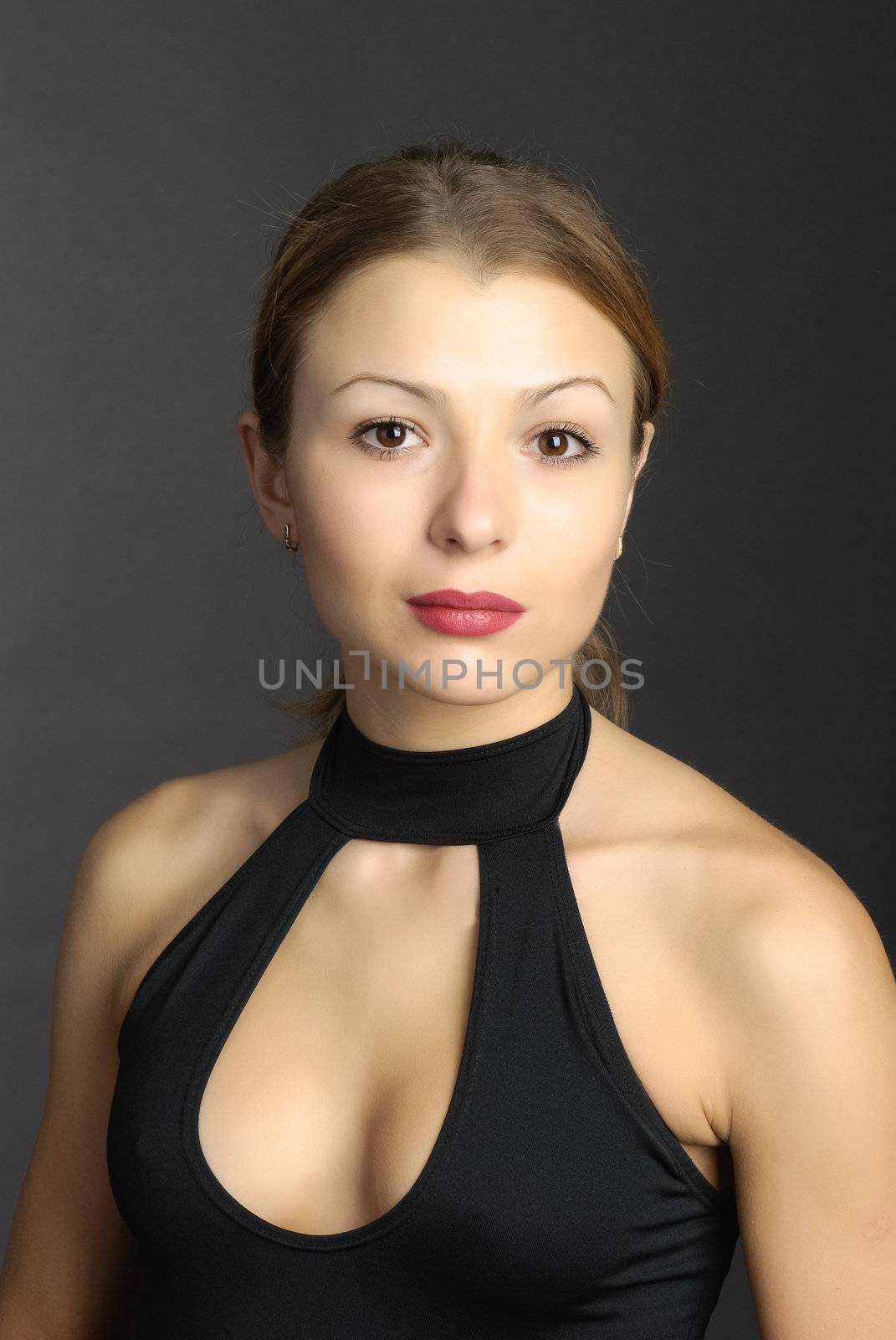 Smiling woman posing on a black background.