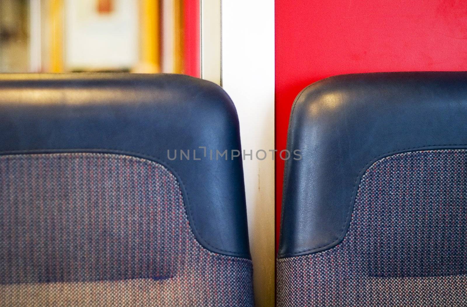 A train seat abstract with dominant blue and red colors.
