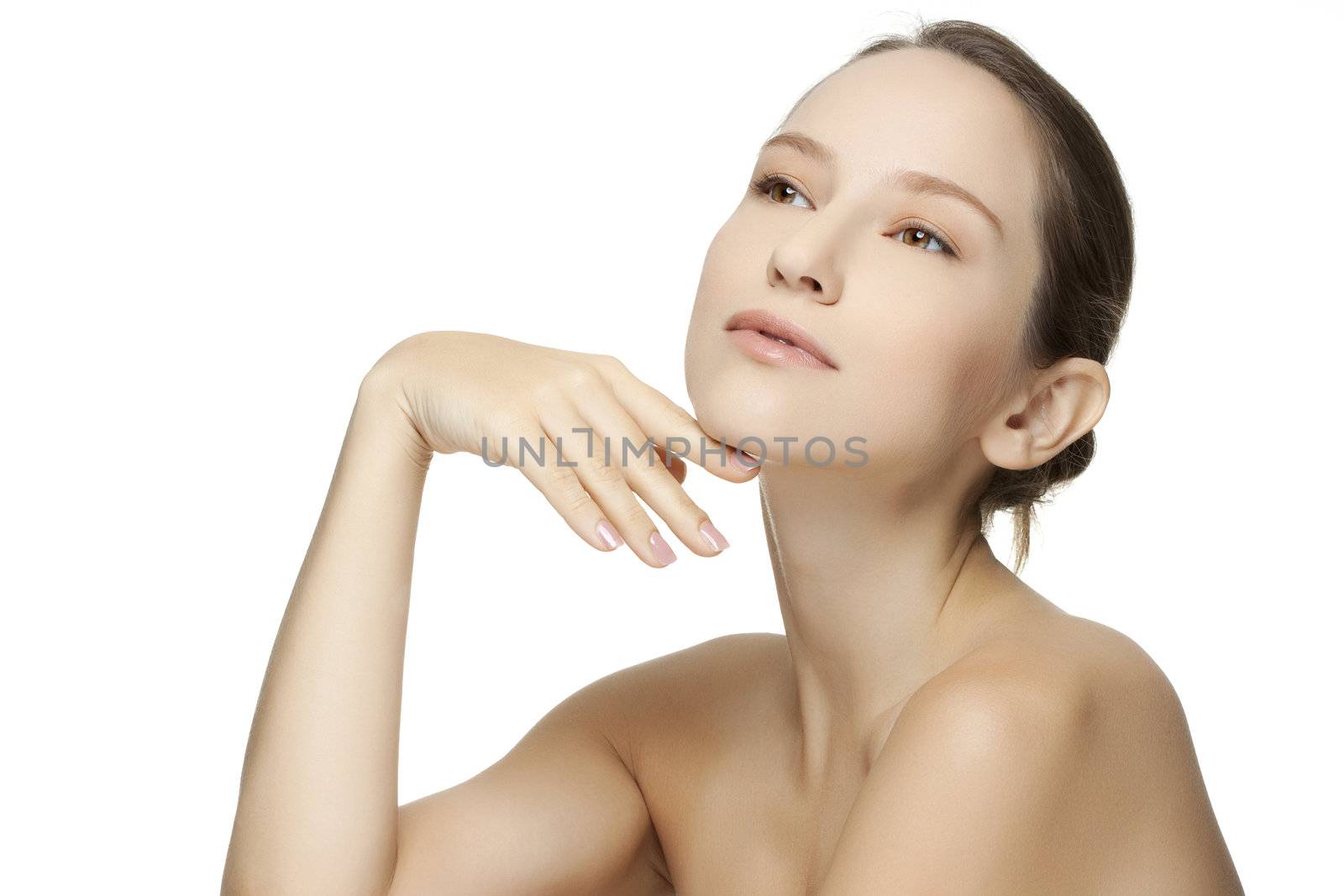 Beautiful young woman with clean skin of the face. Pretty female posing on white background