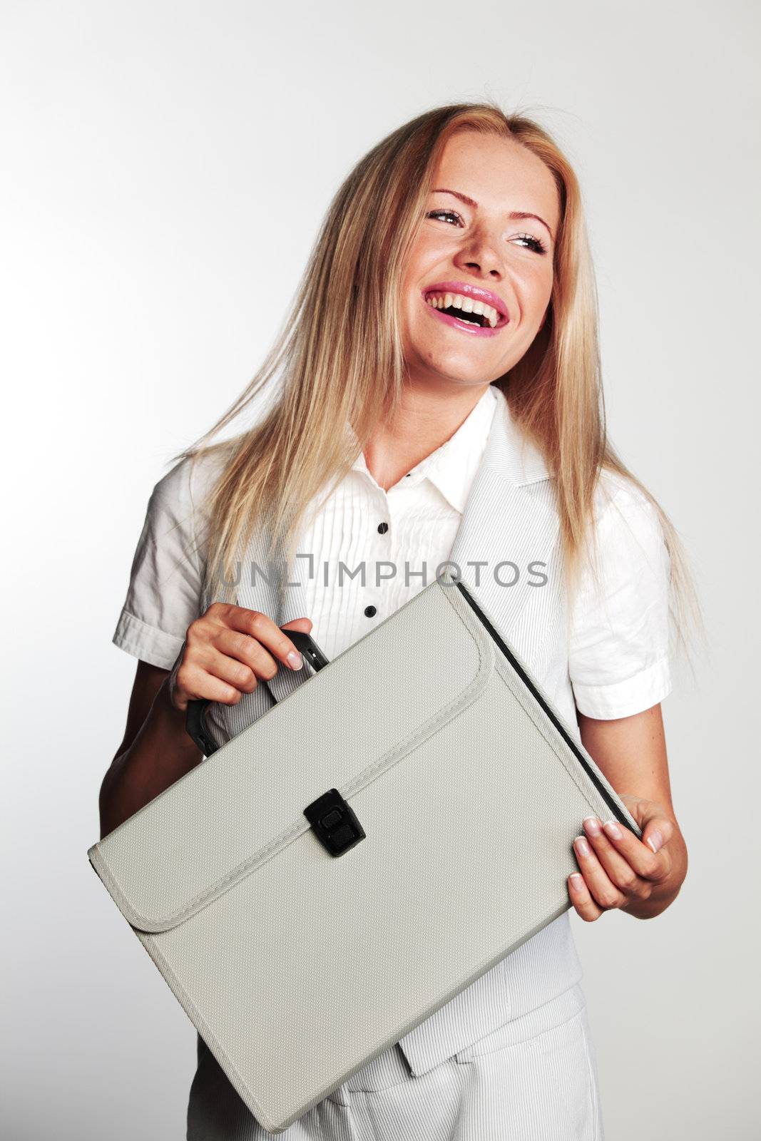  business woman with a briefcase on a gray background