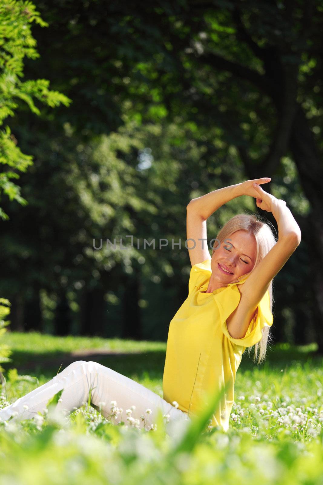 happy woman sitting on grass