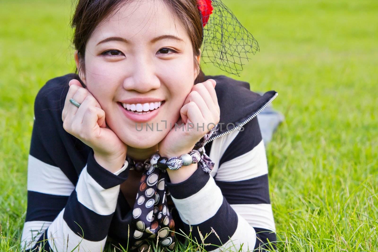 Asian woman relaxing on the grass