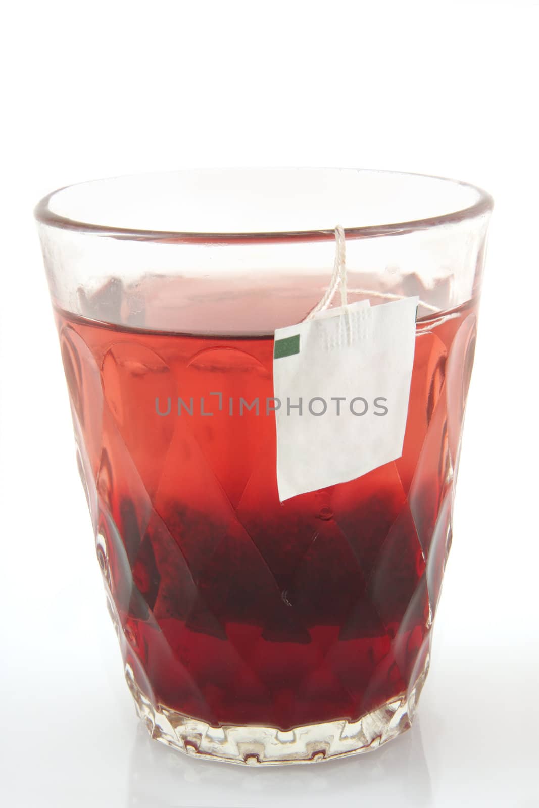 Glass of hot tea on a white background