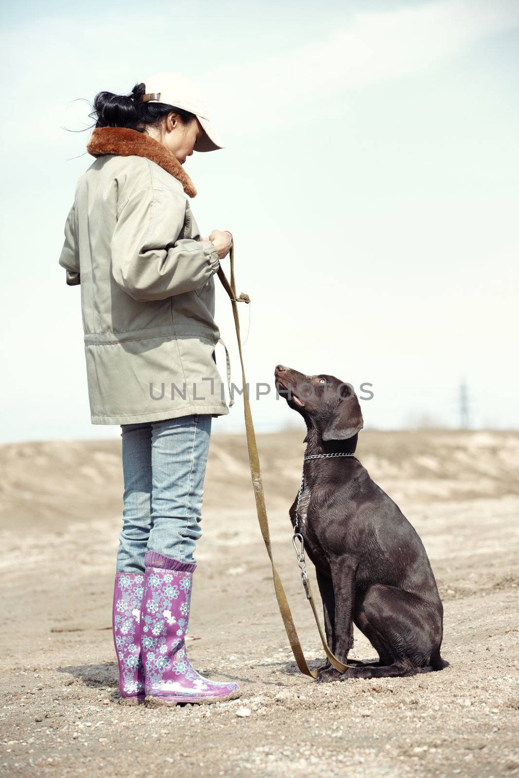 Woman and dog training outdoors