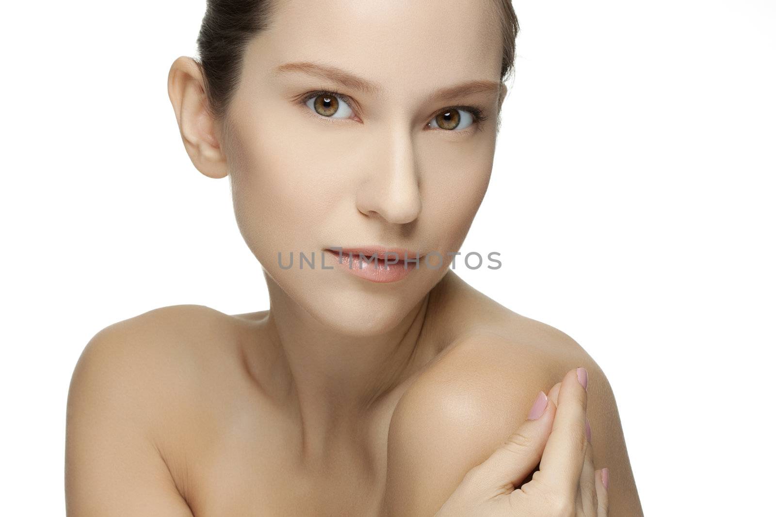 Beautiful young woman with clean skin of the face. Pretty female posing on white background